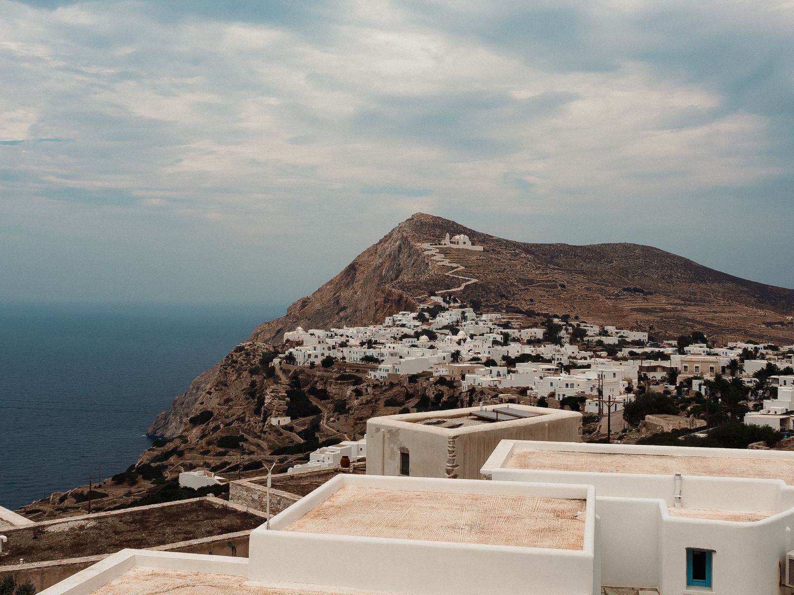 White village on a cliff top above the sea in Folegandros, Greece, a setting for cultural cruises in Europe