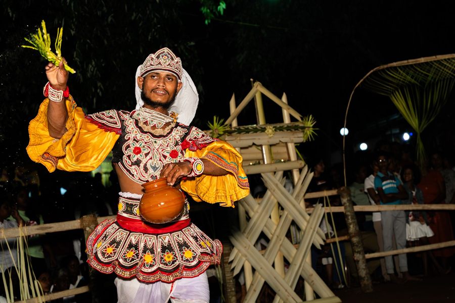Kandyan dancer in a traditional Sri Lankan costume performing at night