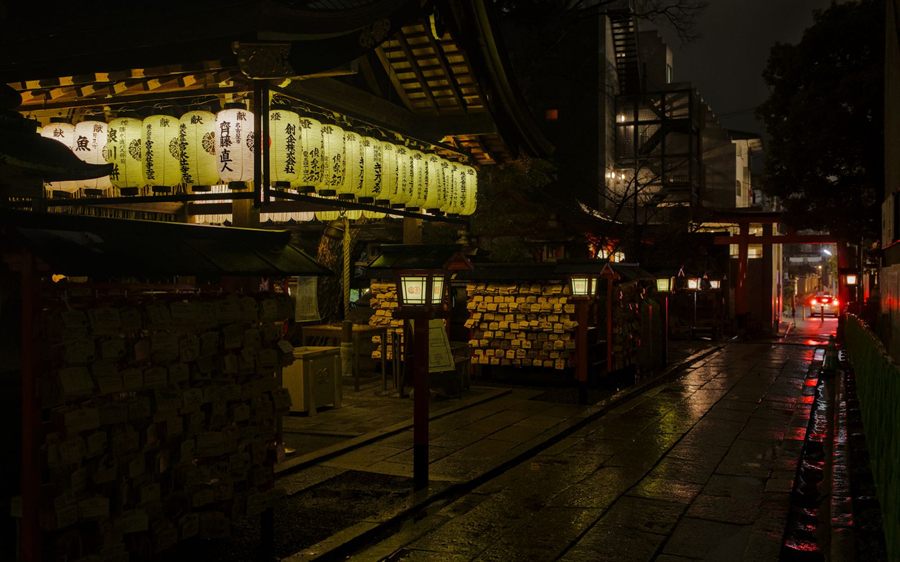 Kyoto lane at night lit by rows of paper lanterns