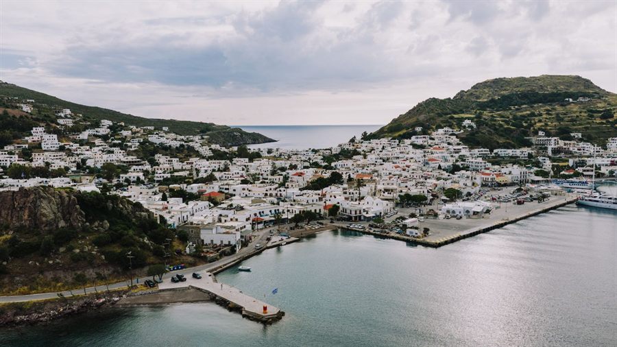 Harbor town of Patmos with white houses climbing the hillside