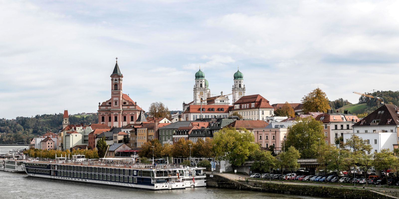 River ship moored below the churches of Passau on the Danube, a classic stop on cultural river cruises
